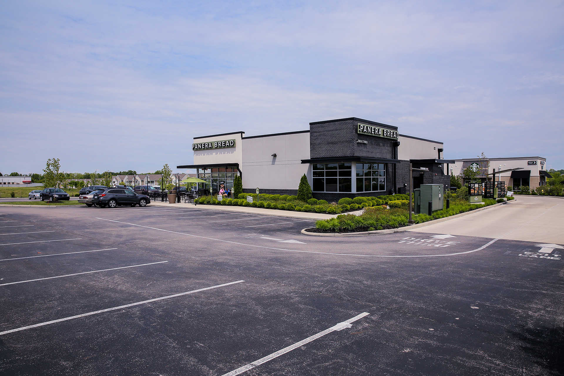 a parking lot and Panera restaurant building
